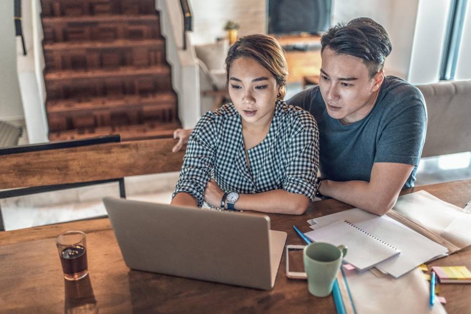 Man and woman doing research on a laptop in the dining room”