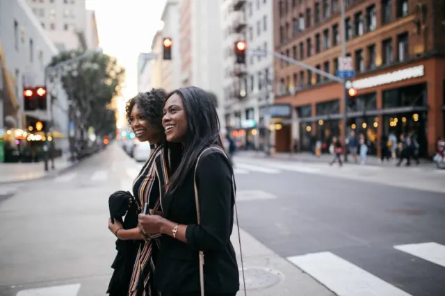 A mother and daughter crossing the street in downtown Jackson, MS