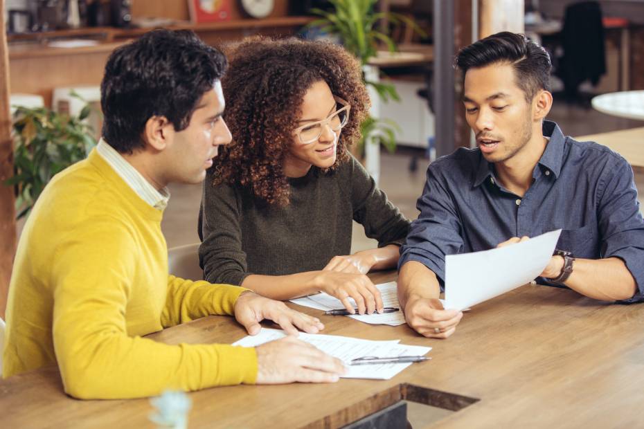 3 people looking at documents