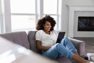 A woman reading a book on the couch