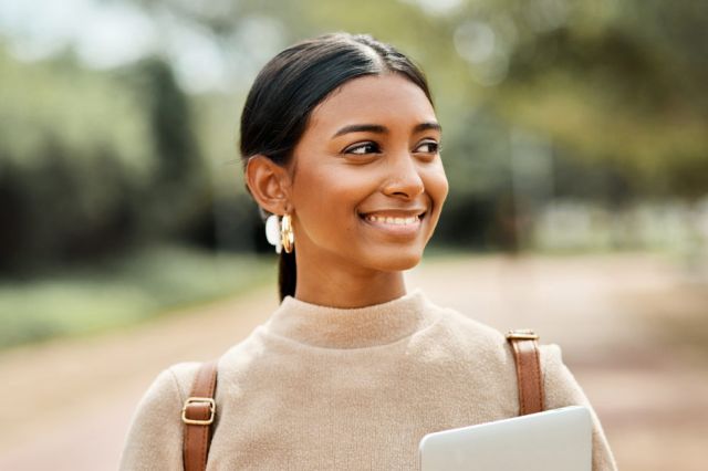 Cropped portrait shot of an attractive young female student on outside campus