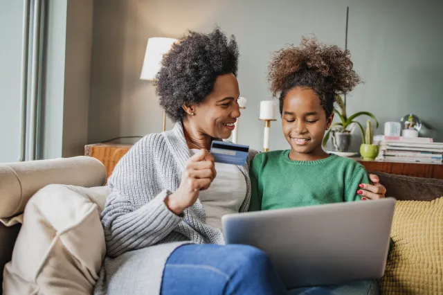 A mother and a child looking at the laptop