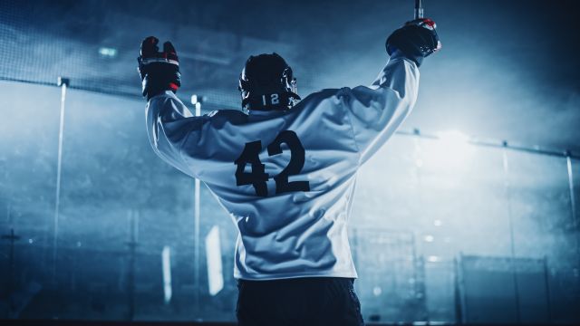 Hockey player raising their arms in victory