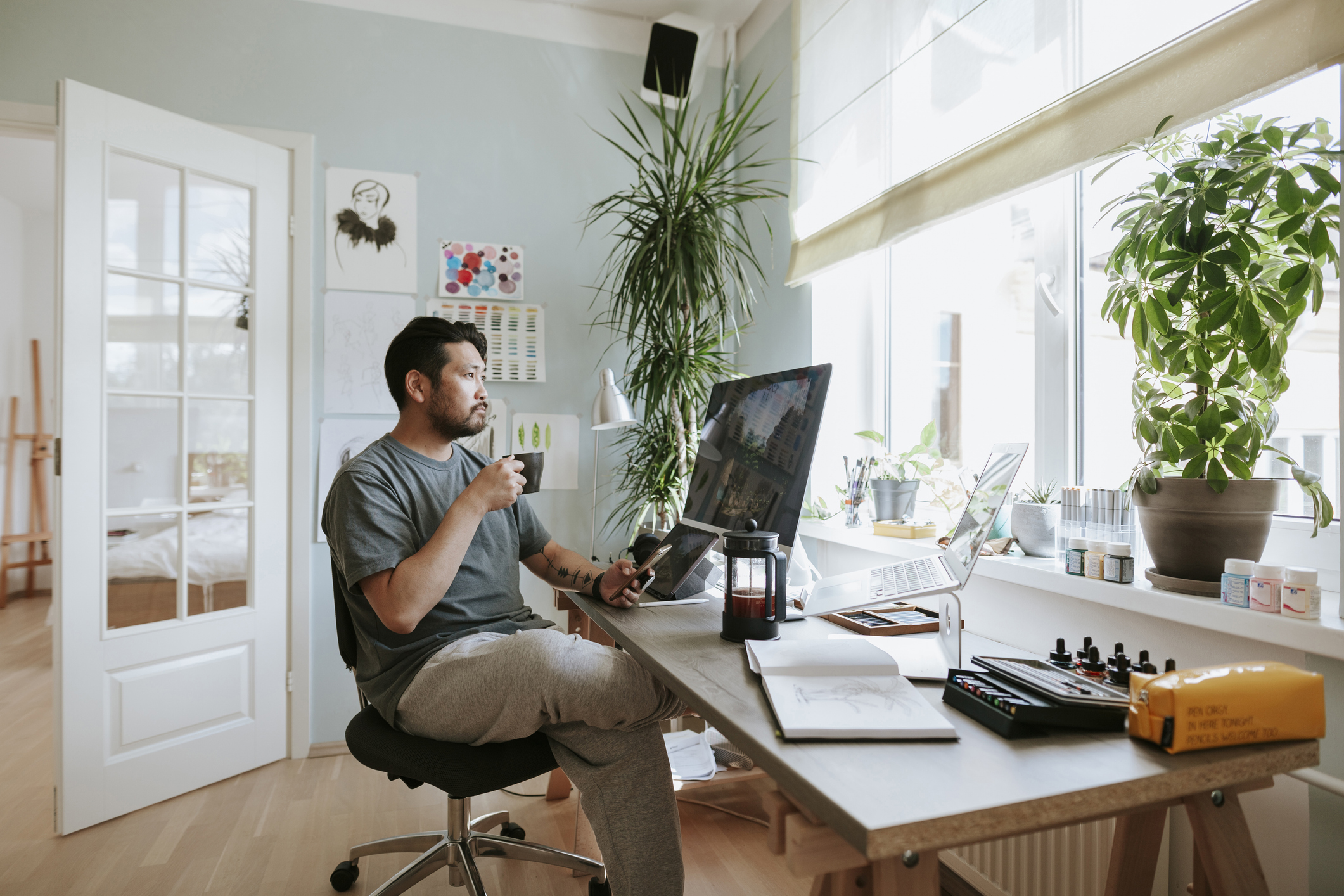 Japanese digital artist at his home studio taking a coffee break.