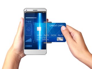 hand holding a smartphone with a processing image of mobile payments from credit