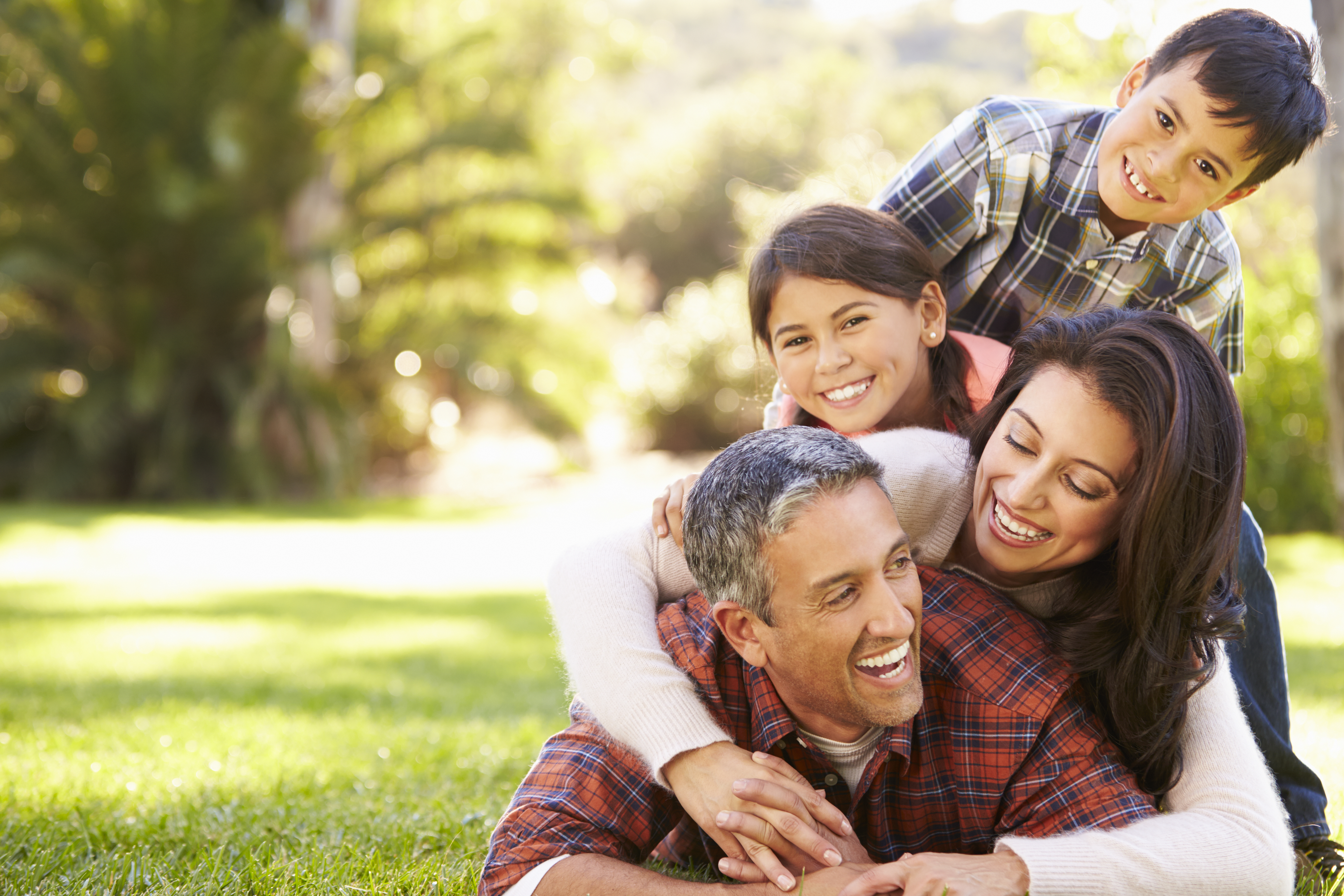 Family laying on grass in countryside