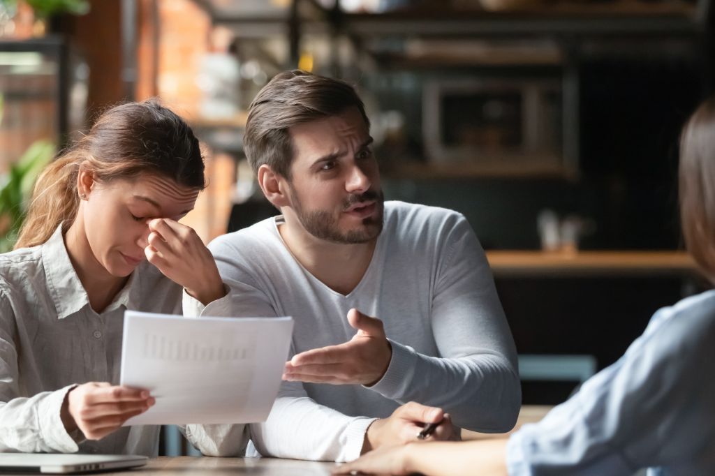 Angry young couple looking at a contract