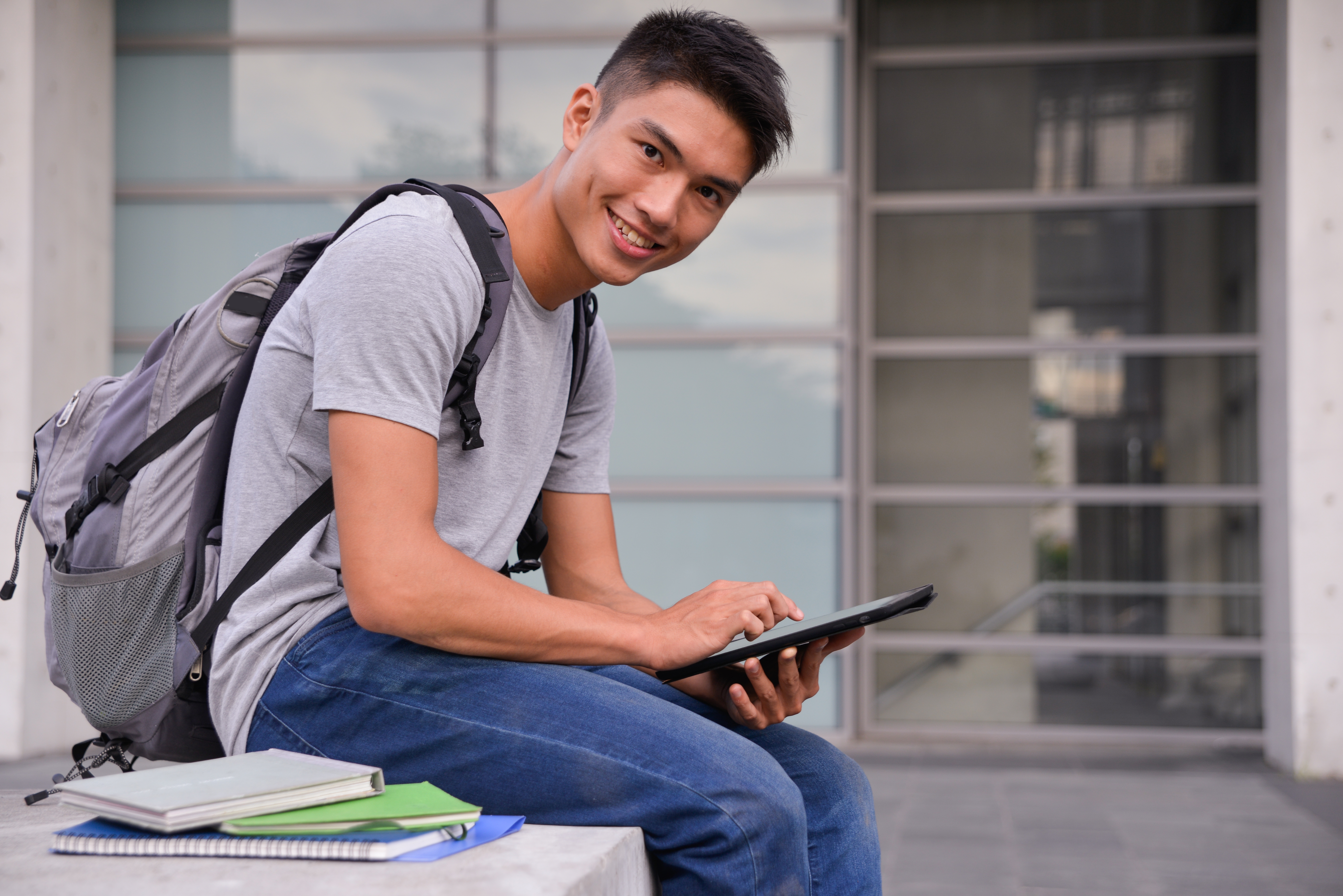 Male student sitting outdoors