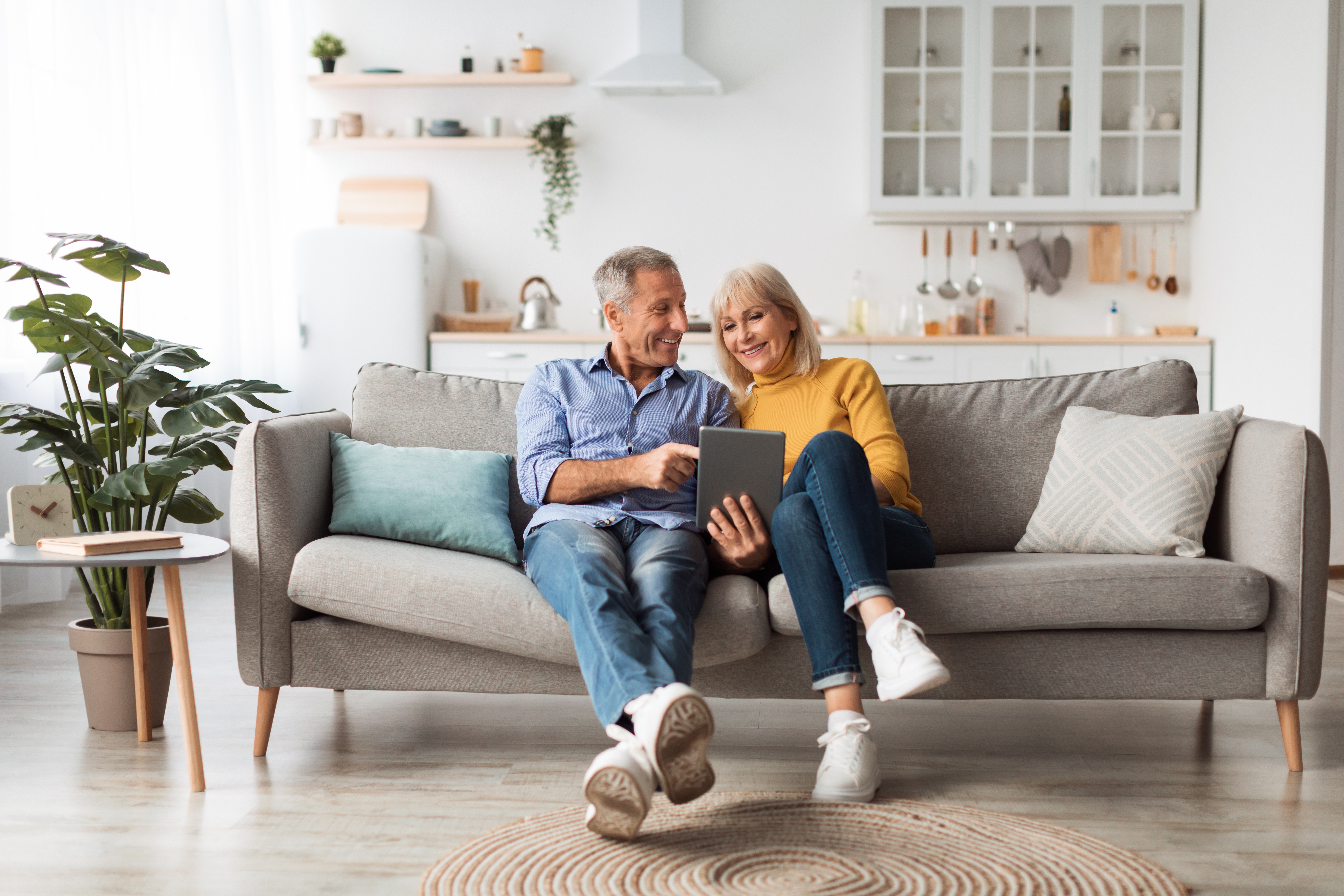 Cheerful spouses using digital tablet together