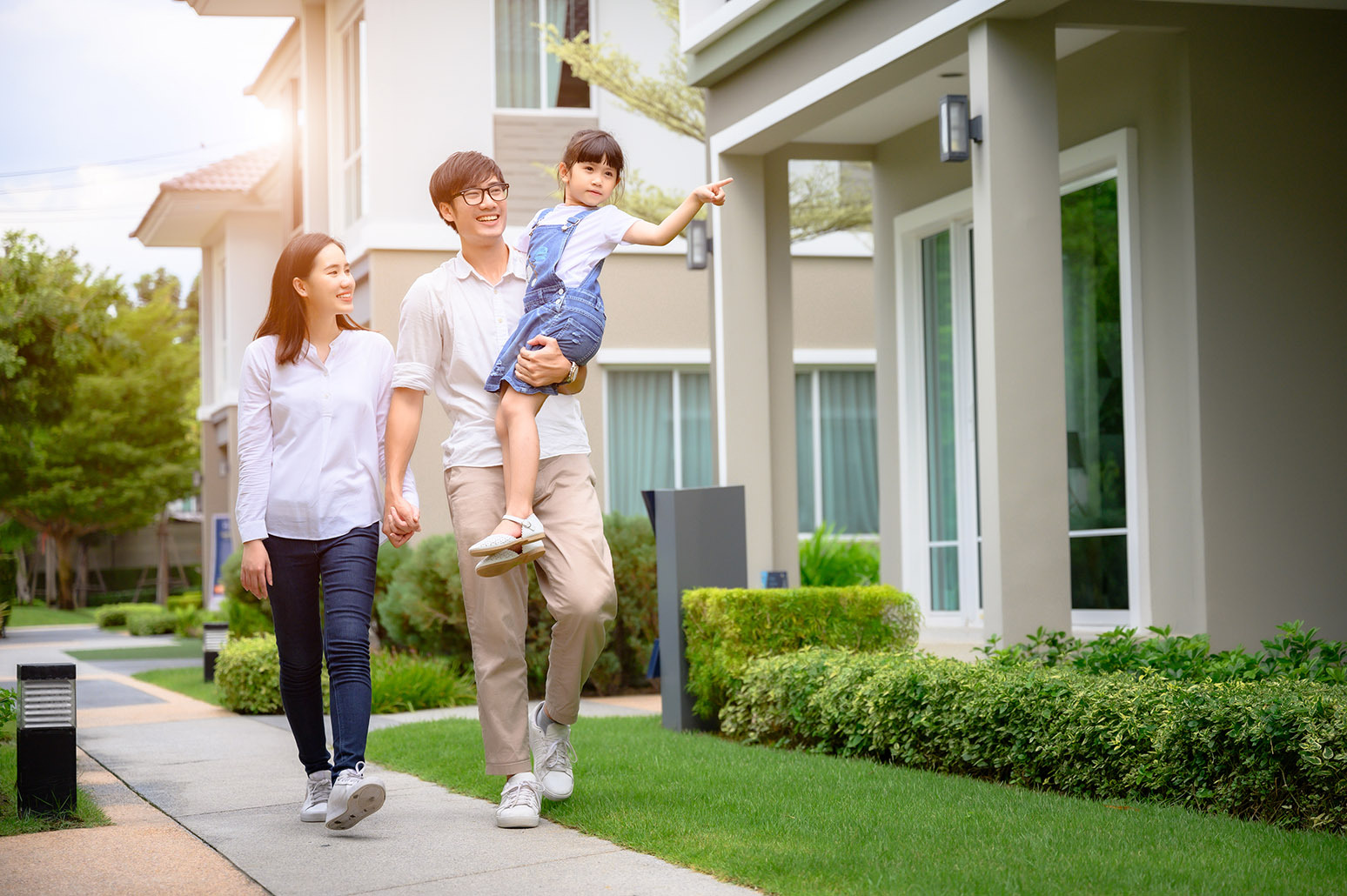 A happy family walking in a neighborhood