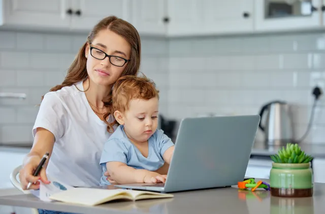 A mother and baby with a laptop