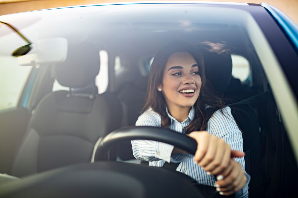 A newcomer to Canada having obtained her provincial driver’s license drives her car confidently