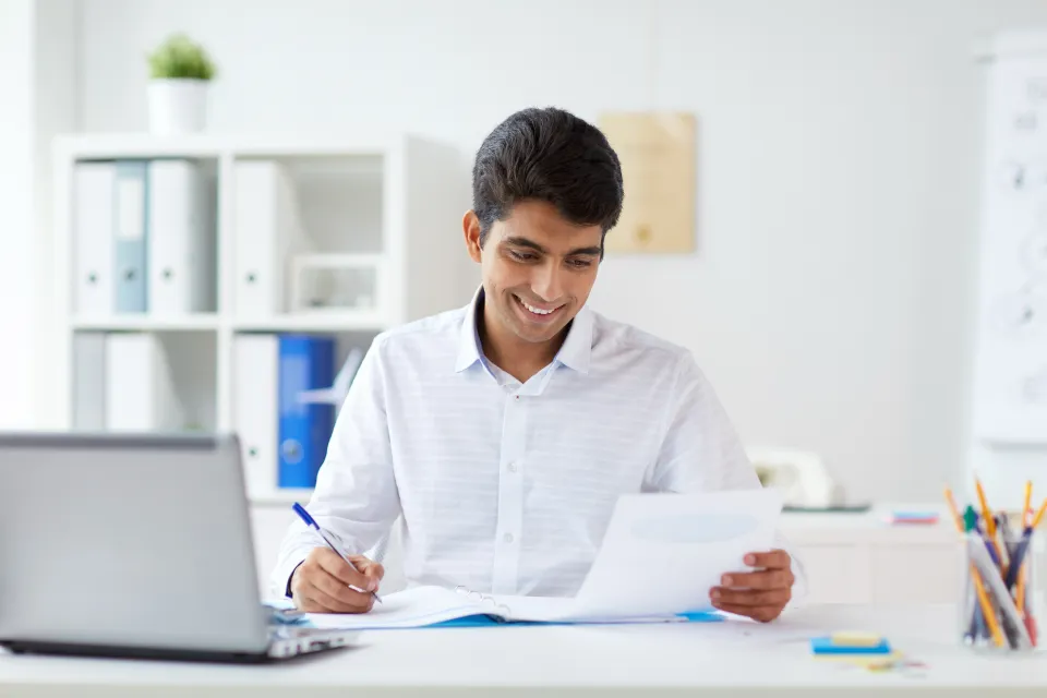 A businessman with papers on a table