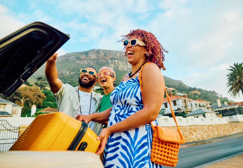 Three happy friends capture a cheerful moment with a selfie during their travel adventure